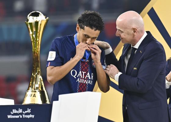 FIFA President Gianni Infantino (R) presents a medal to Marquinhos of Paris Saint-Germain after they won the FIFA Intercontinental Cup 2025 match between Paris Saint-Germain and CR Flamengo at Ahmad Bin Ali Stadium in Al-Rayyan, Qatar, 17 December 2025. 