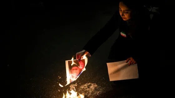 A protester burns images of Iranian Supreme Leader Ali Khamenei during rally in support of the nationwide mass demonstrations in Iran against the government, in Zuerich, Switzerland, 13 January 2026. 
