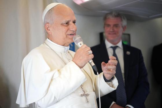 Pope Leo XIV (L) speaks to journalists aboard the papal flight from Malabo, Equatorial Guinea to Rome, Italy, 23 April 2026, at the end of his 11-day apostolic journey to Africa.