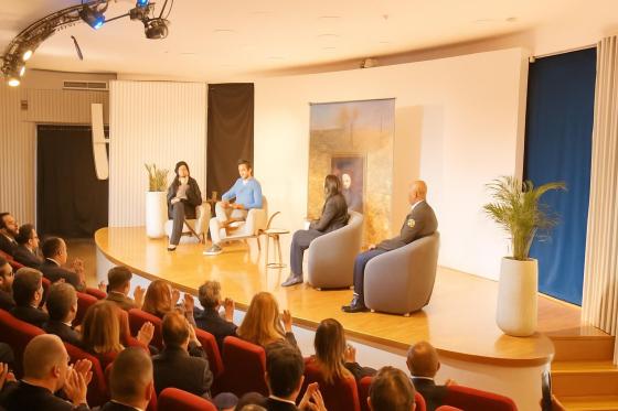 Grupo de personas discutiendo sobre deporte y ciudad en un evento
