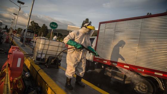 Un trabajador desinfecta los vehículos que quieren ingresar a la capital del país, durante el periodo de cuarentena impuesta para frenar la propagación de Coronavirus.  Foto: Juancho Torres/ Anadolu