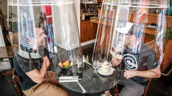 El diseñador francés Christophe Gernigon posa con su creación 'la burbuja de plexiglás' que rodea a los clientes para protegerlos de la infección por covid-19 durante una presentación en el restaurante HAND en París.   Foto: Christophe Petit Tesson - EFE